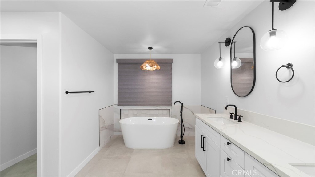Bathroom remodel with freestanding tub and vanity