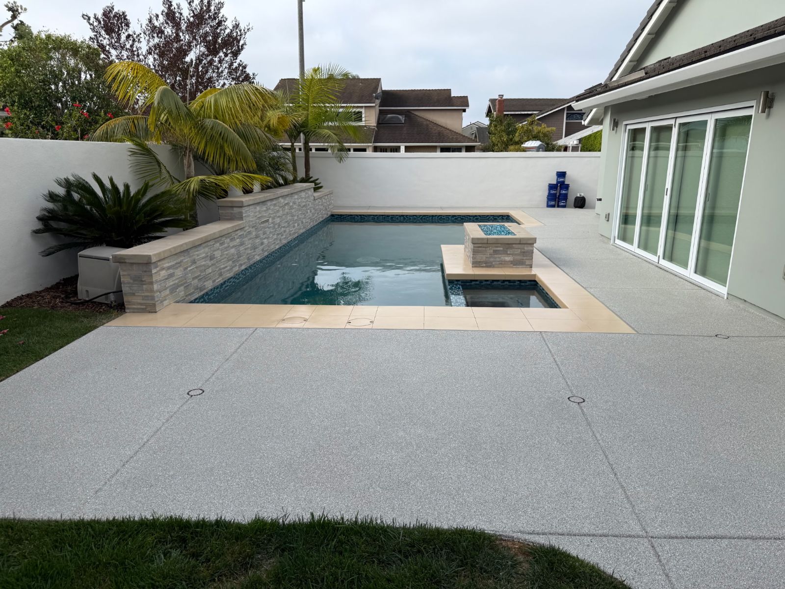 Clean pool deck finish around backyard pool